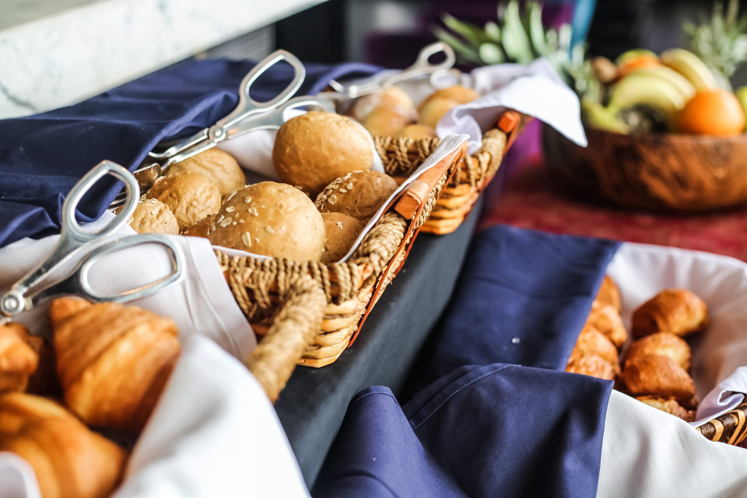 Brötchen und Croissants in Körben am Frühstücksbuffet